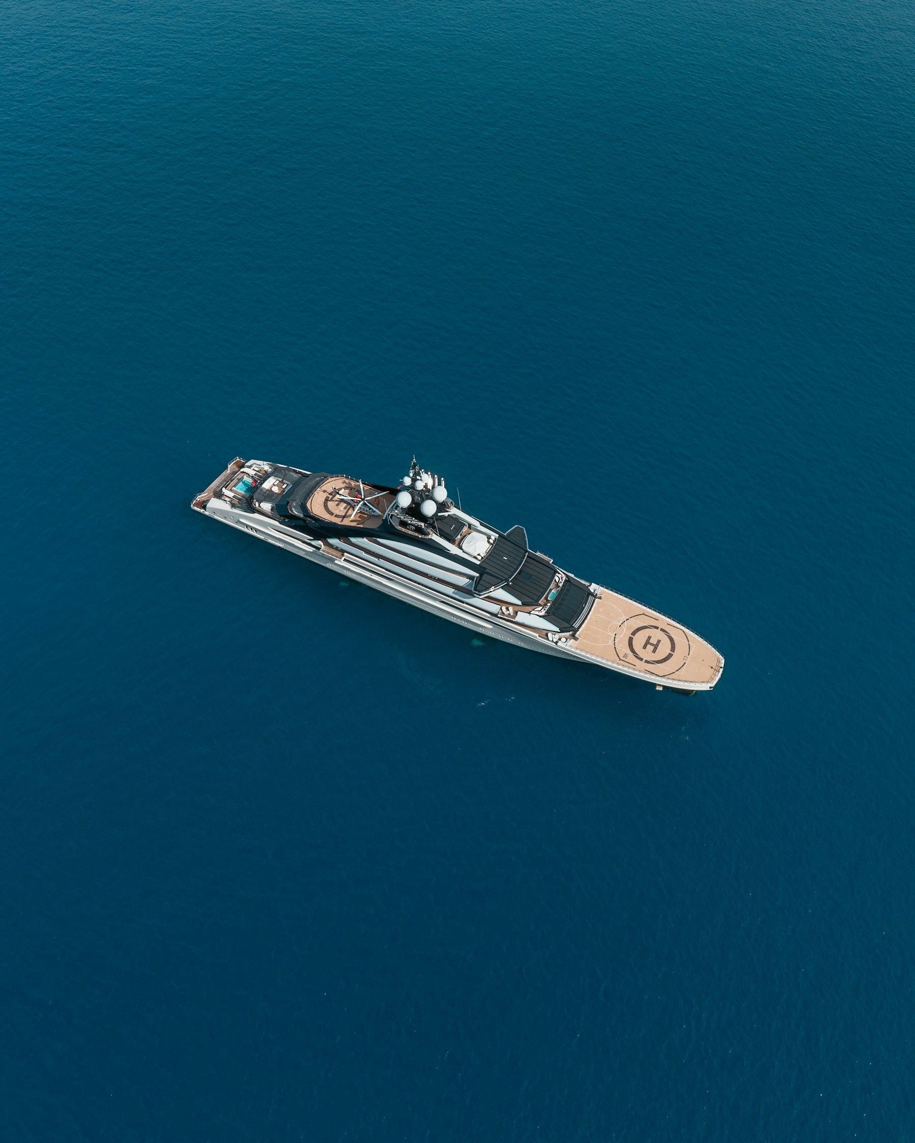 A motor yacht at anchor in deep blue water